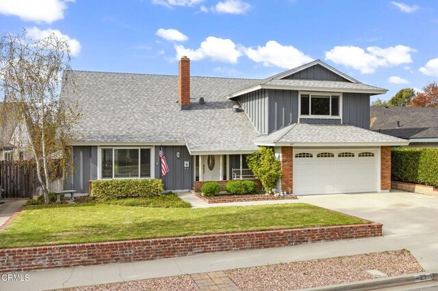 view of front property with a garage and a front lawn