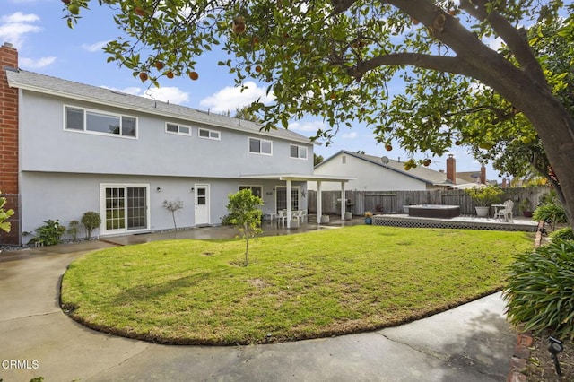 rear view of property with a patio area and a lawn