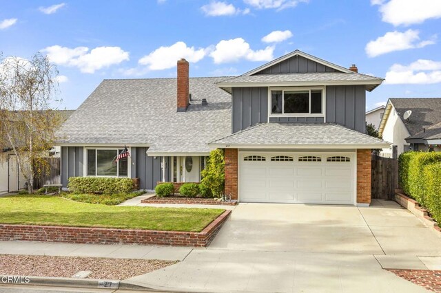 view of front of home with a front lawn and a garage