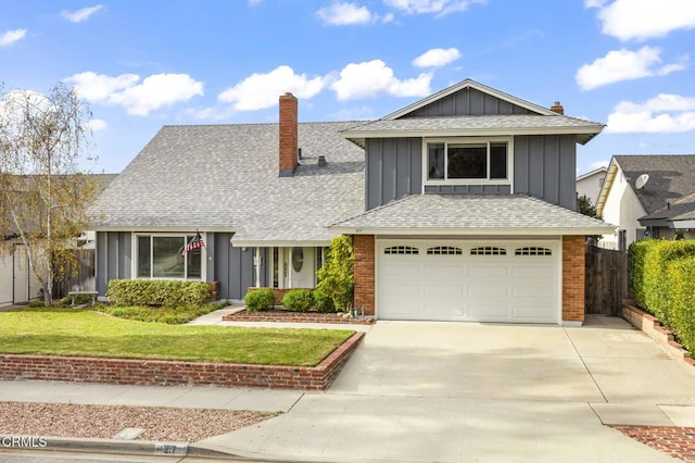 view of front of property with a front yard and a garage