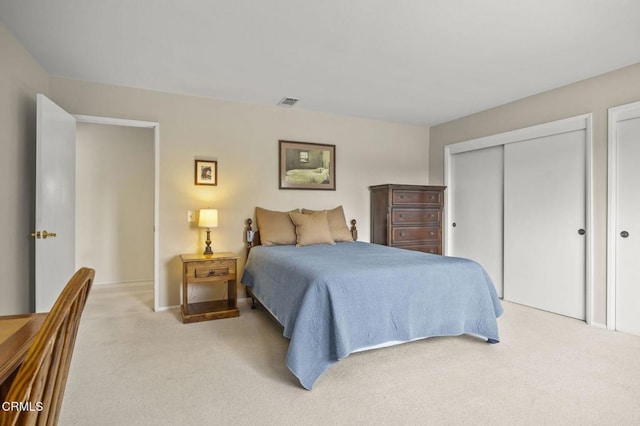 bedroom with light colored carpet and a closet