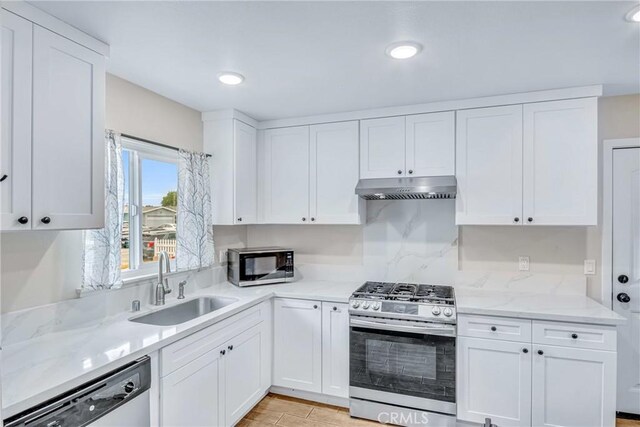 9022 Marlene Ave, Garden Grove, CA 92841 - kitchen featuring stainless steel appliances, a sink, under cabinet range hood, white cabinets, and recessed lighting