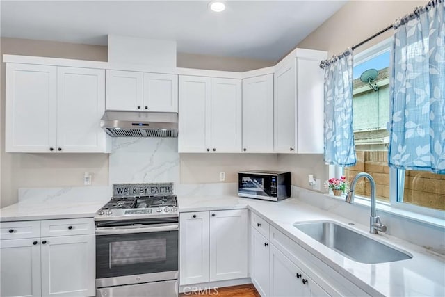 9022 Marlene Ave, Garden Grove, CA 92841 - kitchen featuring stainless steel appliances, under cabinet range hood, a sink, white cabinetry, and recessed lighting