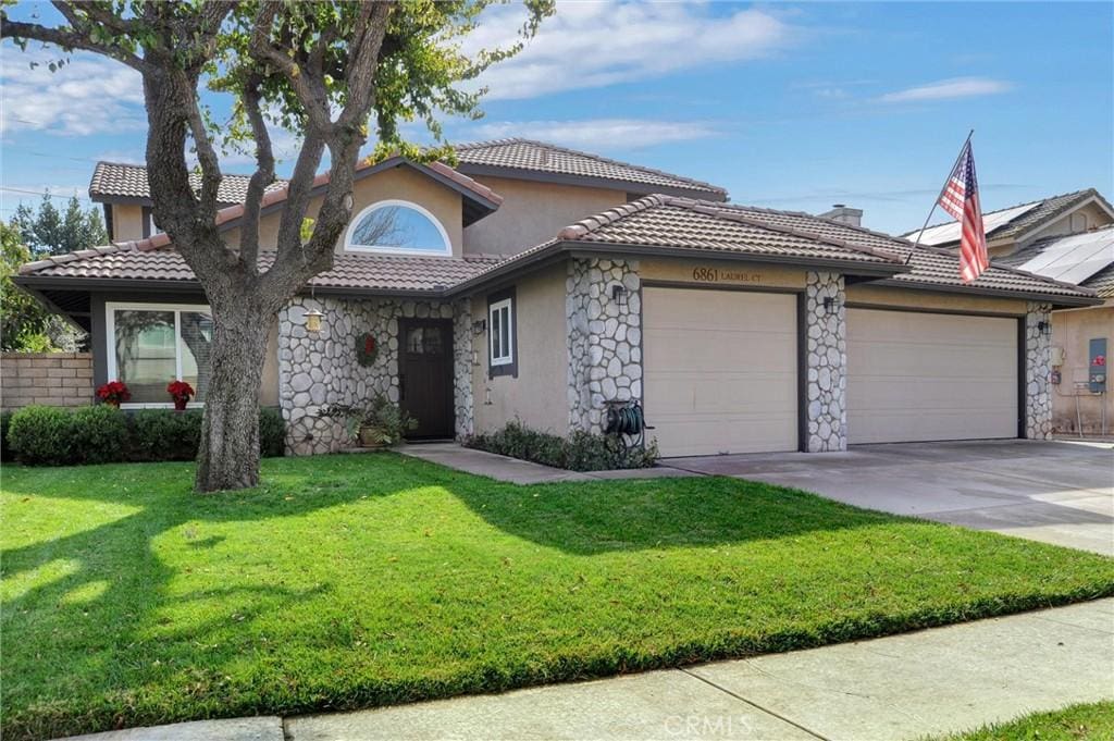 view of front of house with a front yard and a garage