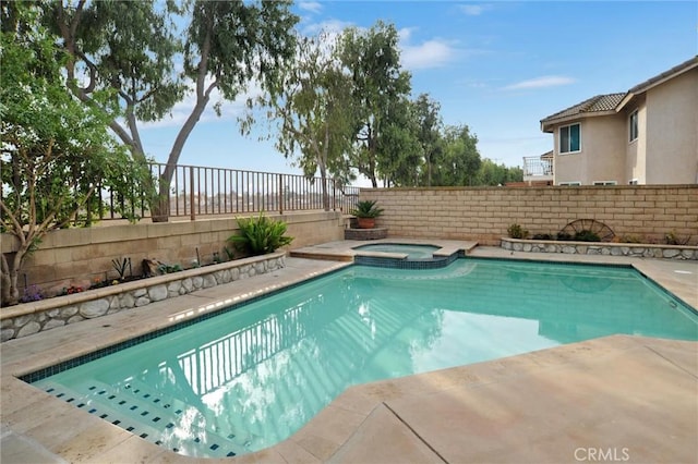 view of swimming pool with an in ground hot tub