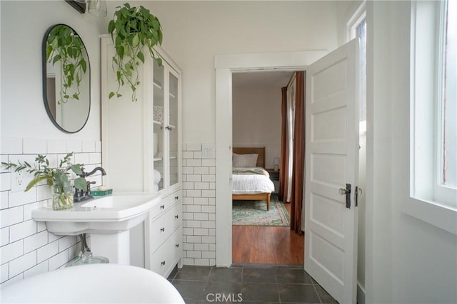 bathroom featuring tile patterned flooring and tile walls