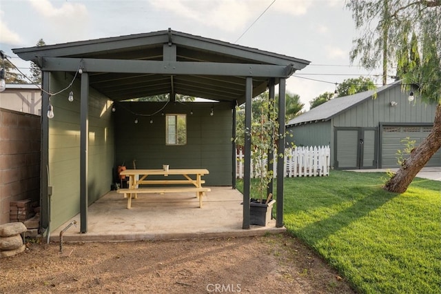 exterior space featuring a garage and a lawn