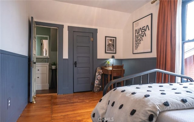 bedroom featuring hardwood / wood-style floors and vaulted ceiling