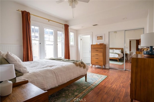 bedroom featuring ceiling fan, a closet, and hardwood / wood-style flooring