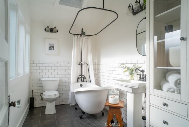 bathroom with toilet, tile walls, tile patterned floors, and separate shower and tub