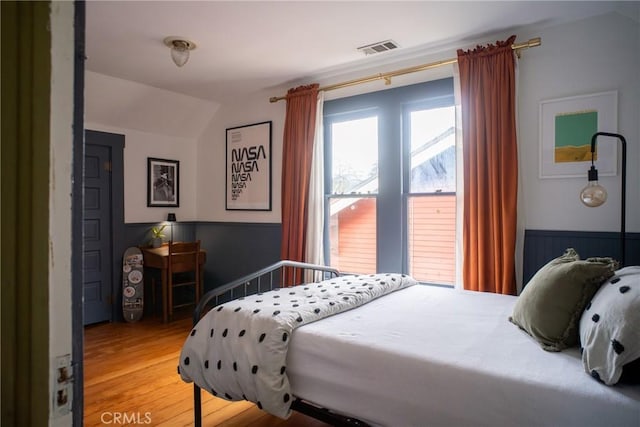 bedroom featuring vaulted ceiling and hardwood / wood-style floors