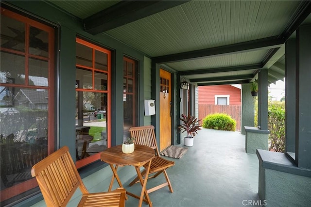 sunroom featuring beam ceiling