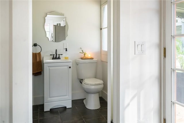 bathroom featuring tile patterned floors, toilet, and vanity