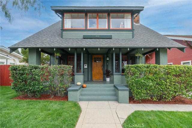 view of front facade with covered porch and a front yard