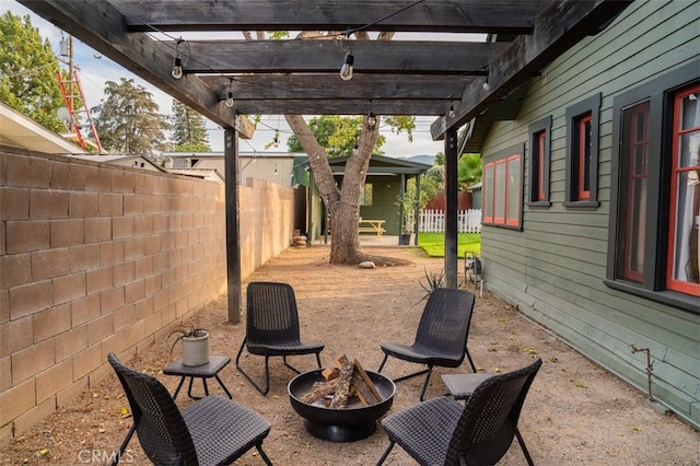 view of patio / terrace with a pergola and a fire pit