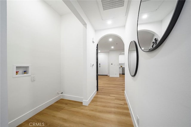 hallway with light hardwood / wood-style floors