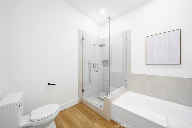 bathroom with hardwood / wood-style floors, independent shower and bath, and toilet