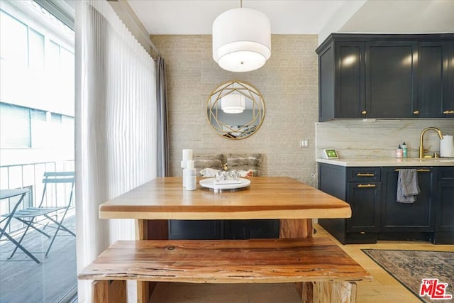 dining space featuring light wood-type flooring and sink