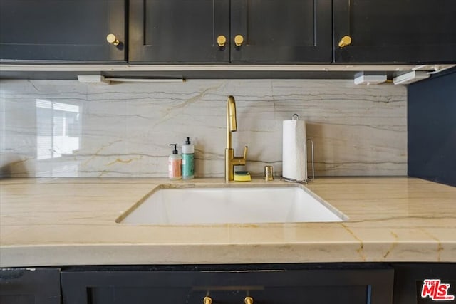 kitchen featuring backsplash and sink