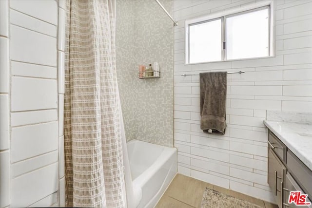 bathroom featuring vanity, tile patterned floors, and shower / bathtub combination with curtain