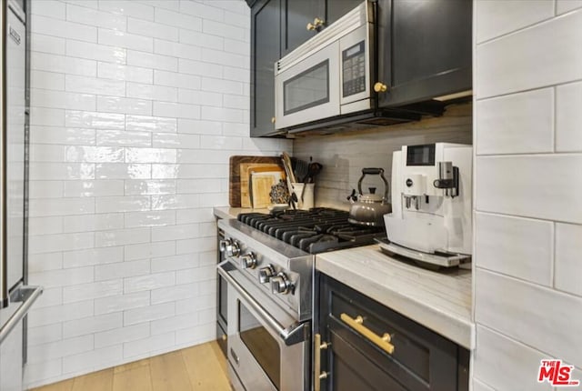 kitchen featuring light wood-type flooring and stainless steel range