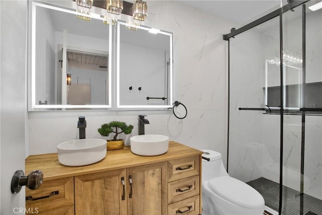 bathroom with toilet, an enclosed shower, and vanity