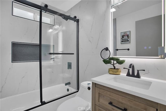 full bathroom with combined bath / shower with glass door, vanity, and toilet