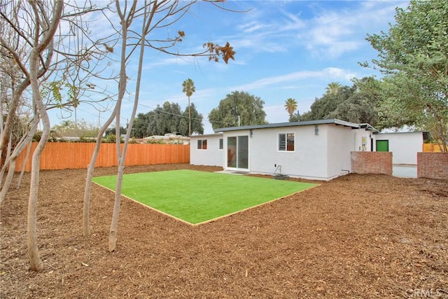 rear view of house featuring a yard