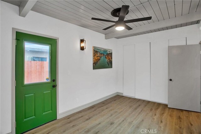 entryway with light wood-type flooring, beam ceiling, ceiling fan, and wood ceiling