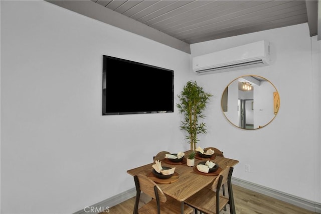 office space with wood ceiling, a wall mounted AC, and light hardwood / wood-style flooring