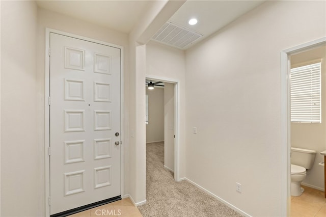 hallway featuring light colored carpet