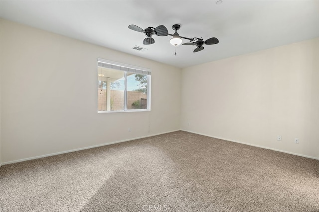 carpeted spare room with ceiling fan