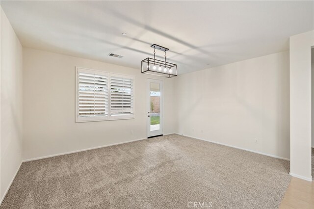 empty room featuring light carpet