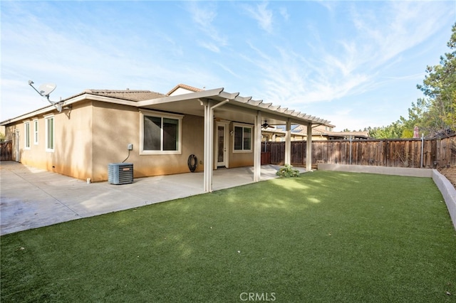 back of house with a patio area, cooling unit, and a lawn