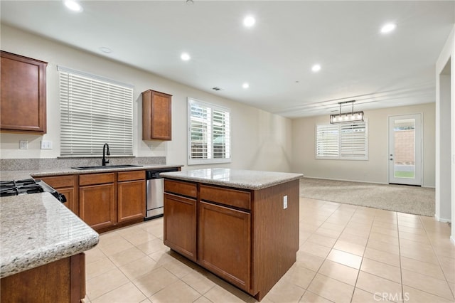 kitchen featuring pendant lighting, a center island, light carpet, sink, and stainless steel dishwasher