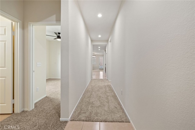 hallway featuring light carpet