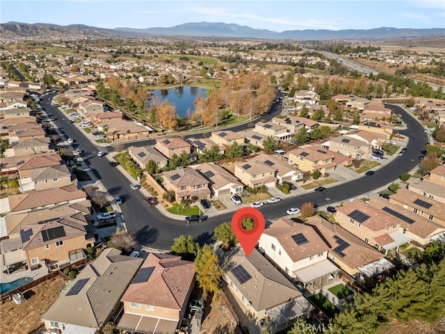 bird's eye view with a water and mountain view