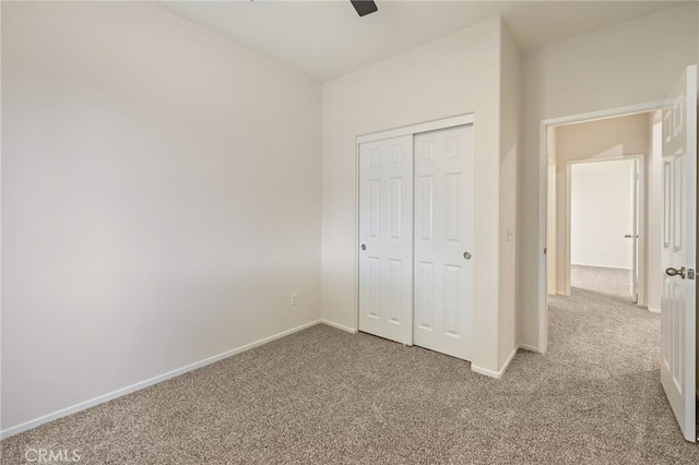 unfurnished bedroom featuring a closet, carpet floors, and ceiling fan