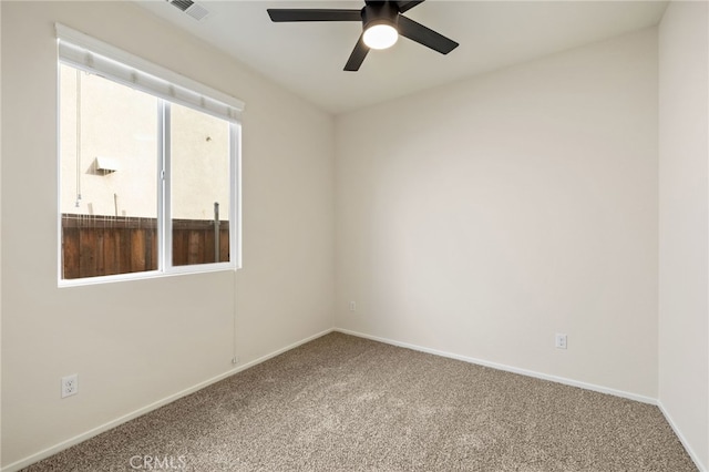 spare room featuring carpet and ceiling fan