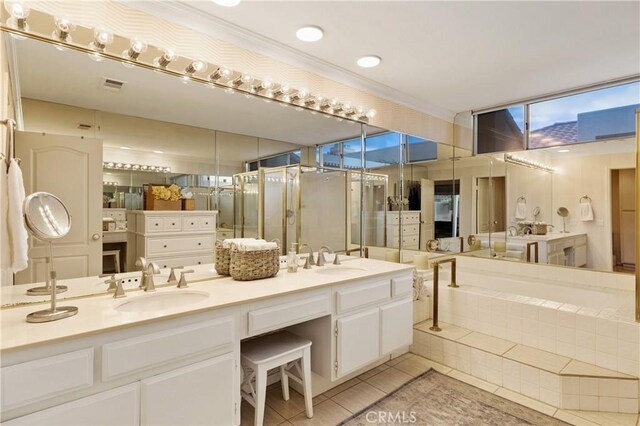 bathroom with tile patterned flooring, vanity, and a tub