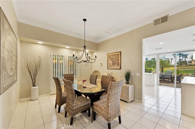 tiled dining room with an inviting chandelier and ornamental molding