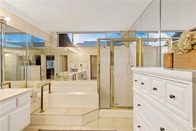 bathroom featuring tile patterned flooring, vanity, and separate shower and tub