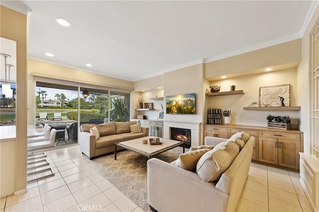 28 Pebble Beach Dr, Rancho Mirage, CA 92270 - living area featuring light tile patterned floors, crown molding, a glass covered fireplace, and recessed lighting