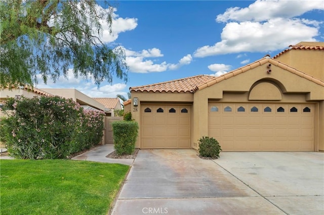 28 Pebble Beach Dr, Rancho Mirage, CA 92270 - mediterranean / spanish house featuring driveway, a garage, a tile roof, stucco siding, and a front lawn