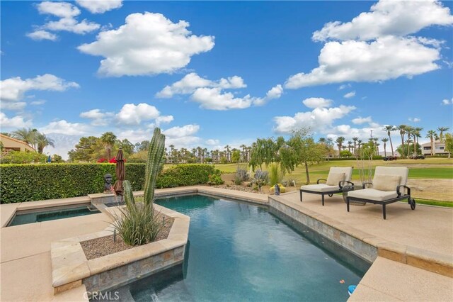 view of pool featuring a patio and an in ground hot tub