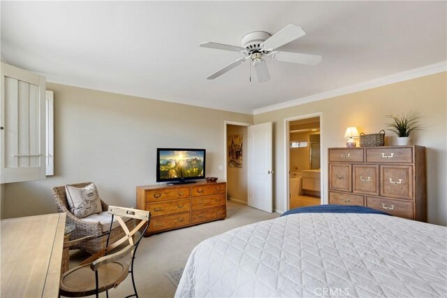 carpeted bedroom featuring crown molding, ensuite bathroom, and ceiling fan