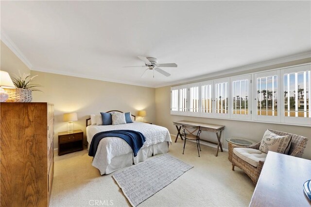 carpeted bedroom featuring crown molding and ceiling fan