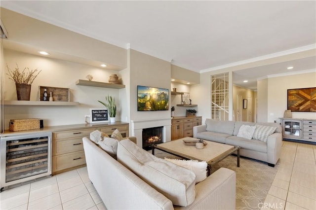 28 Pebble Beach Dr, Rancho Mirage, CA 92270 - living area featuring wine cooler, light tile patterned flooring, crown molding, a lit fireplace, and a bar