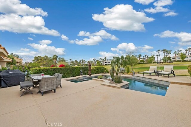 view of pool featuring area for grilling and a patio area