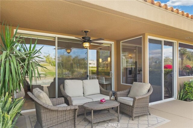 view of patio with ceiling fan and an outdoor living space